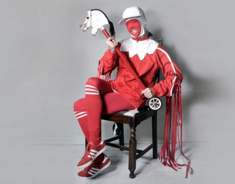 Gazelle Twin sitting in a chair